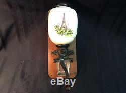 Antique French wall mount coffee bean grinder with Eiffel tower scene depicted