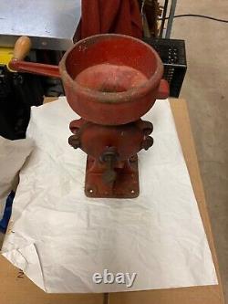 Antique cast iron grain/coffee grinder marked 2mb, 2mc, 16 inches tall red faded