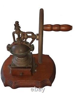 Antique coffee grinder in brass, cast iron and wooden base