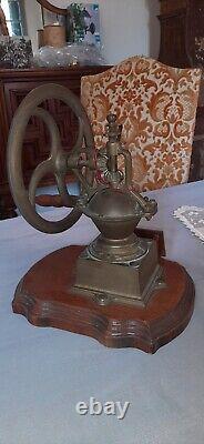 Antique coffee grinder in brass, cast iron and wooden base