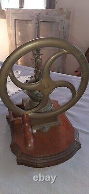 Antique coffee grinder in brass, cast iron and wooden base