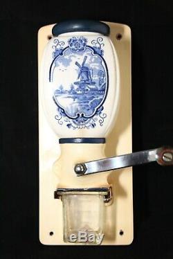 Old vintage wall coffee grinder with blue dutch windmill motif